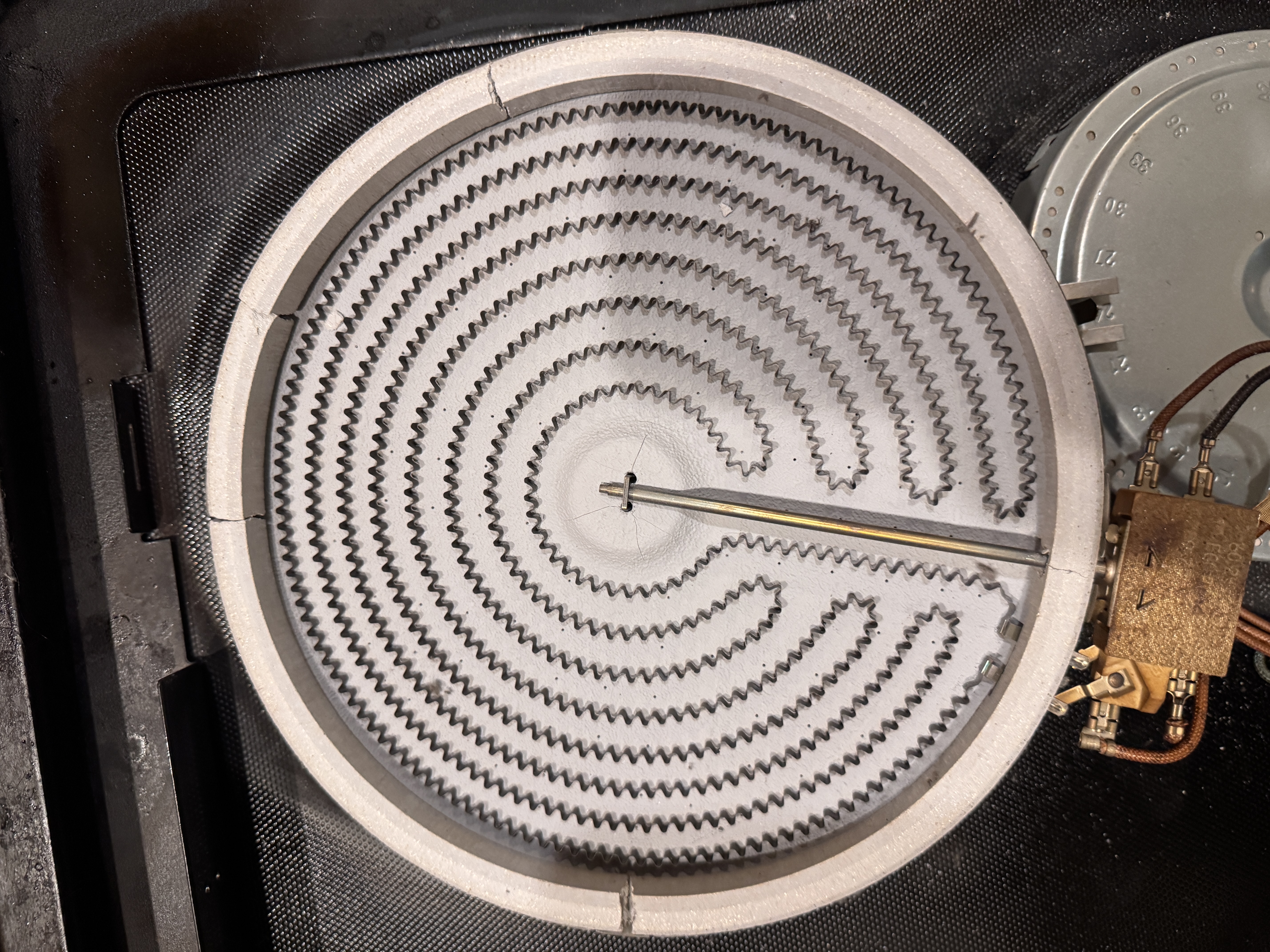 Exposed radiant stove heating element with temperature sensor