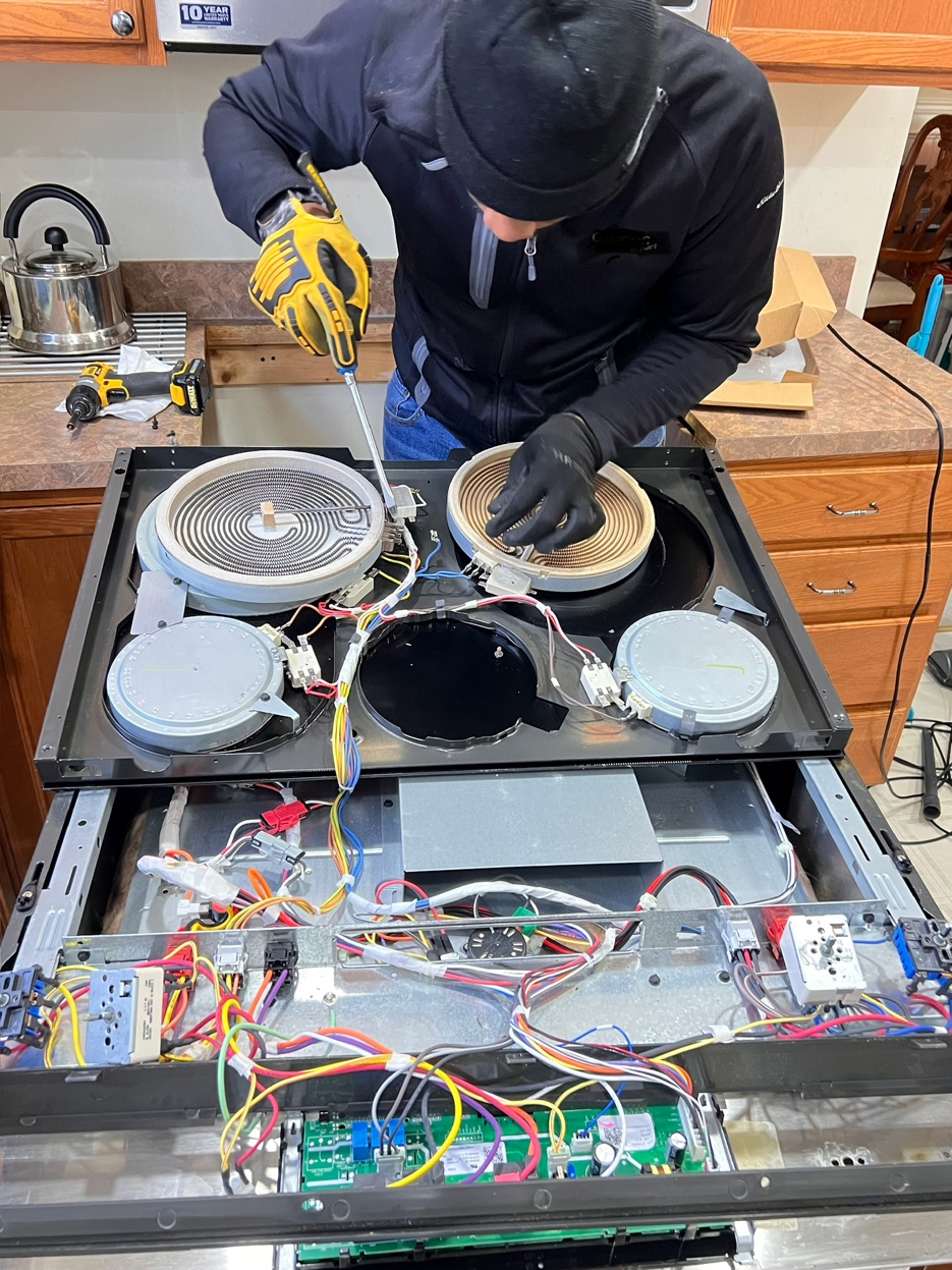 Appliance Intervention technician repairing electric cooktop in Mechanicsburg PA