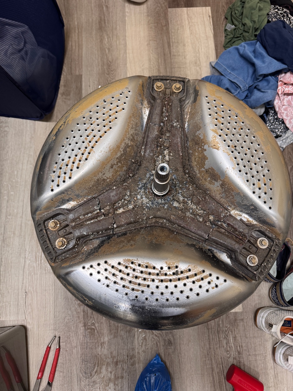 Corroded washer drum spider arm — the source of violent shaking